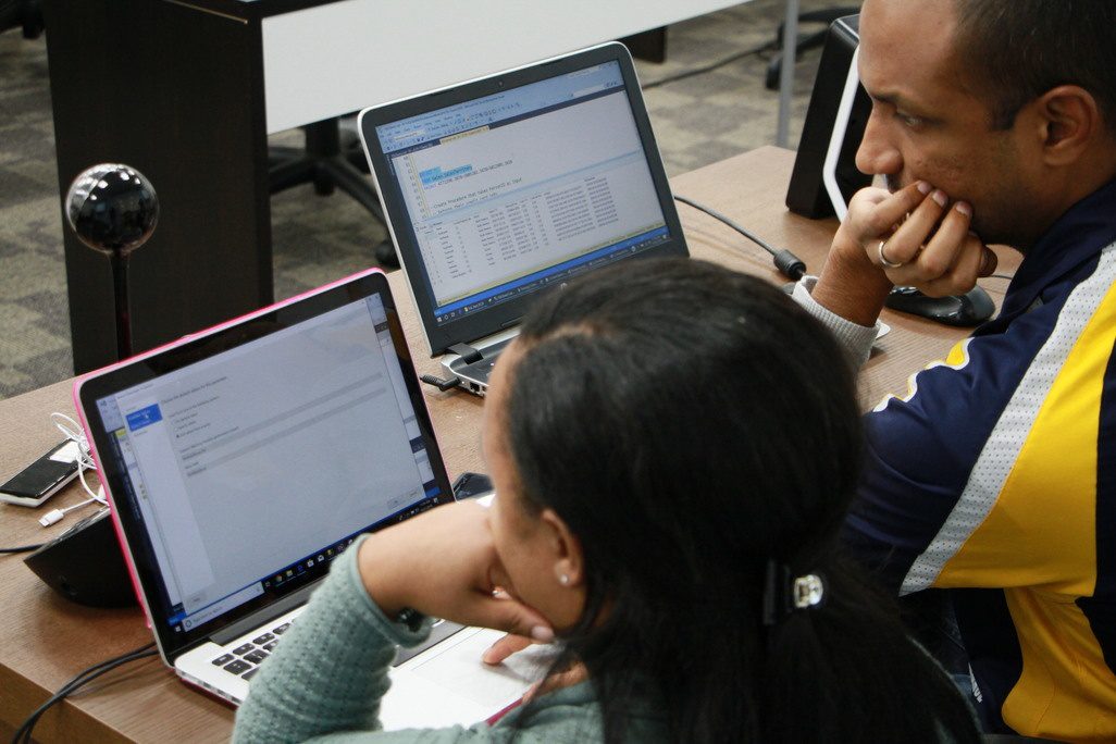 Image of Colaberry student and mentor looking at laptop