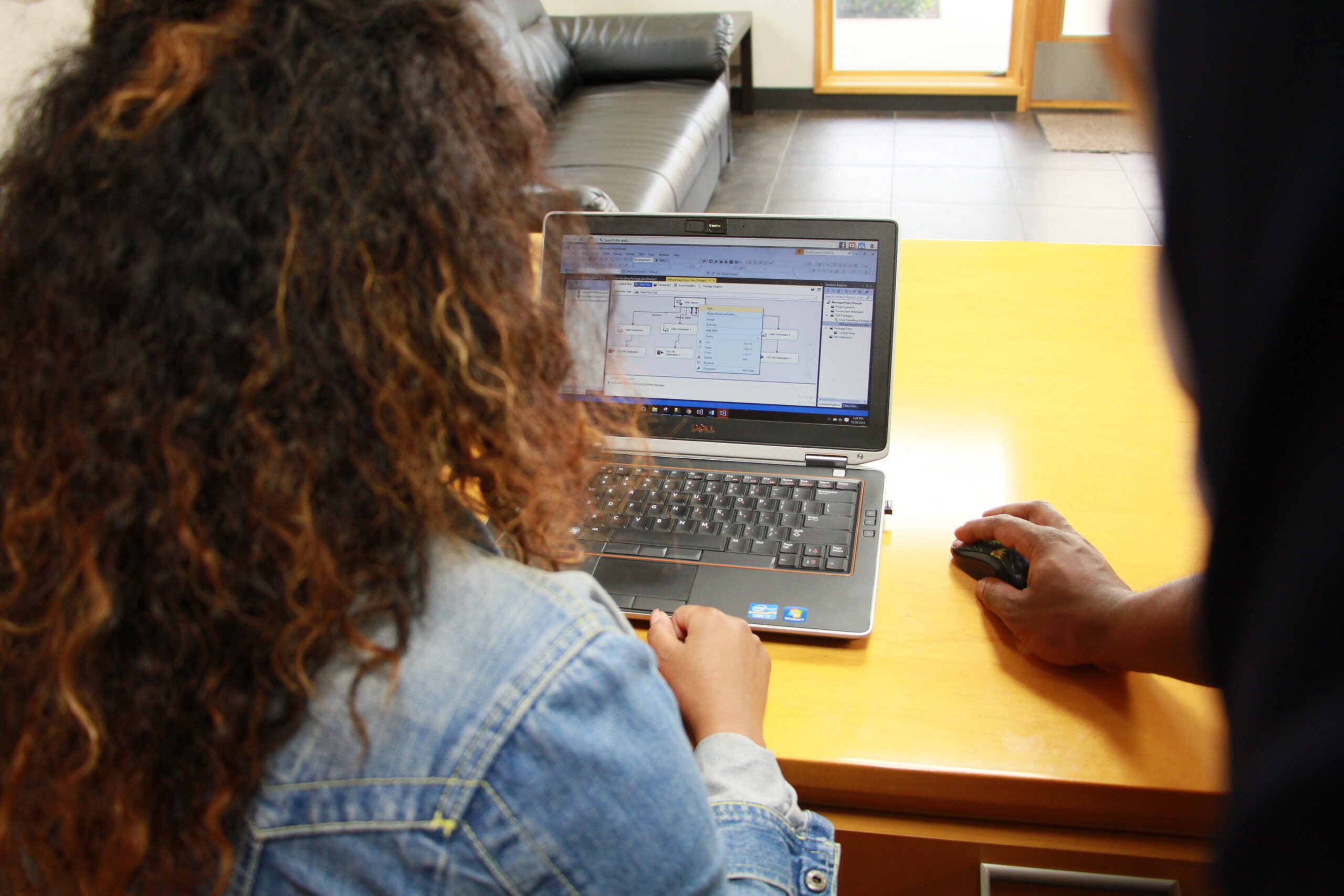 woman at desk working on laptop on SQL