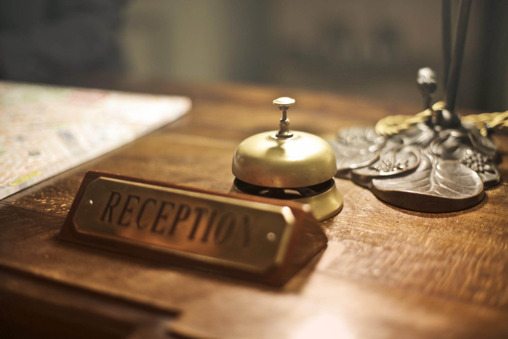Image of bell with reception sign on a desk