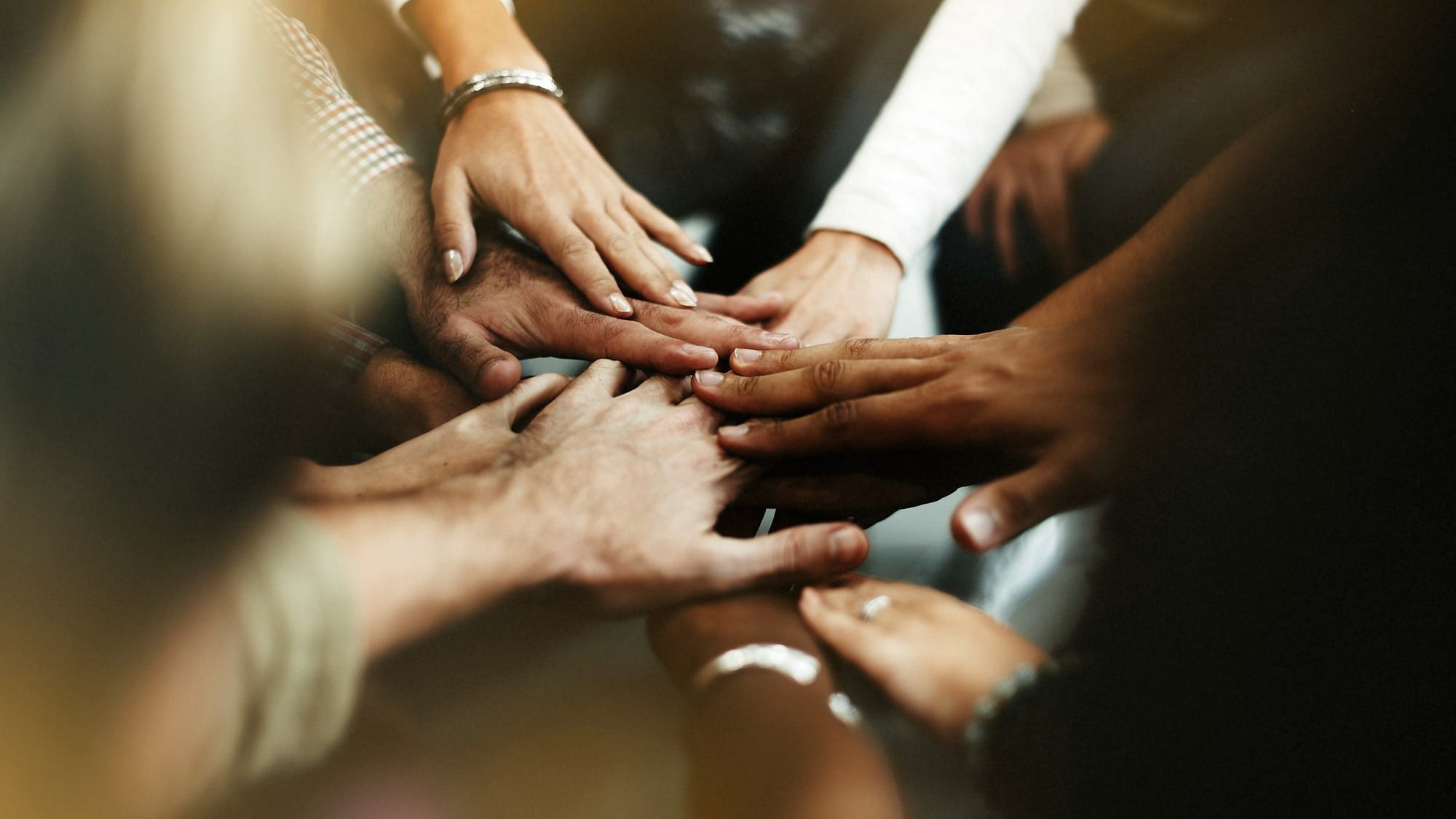 closeup-diverse-people-joining-their-hands.jpg