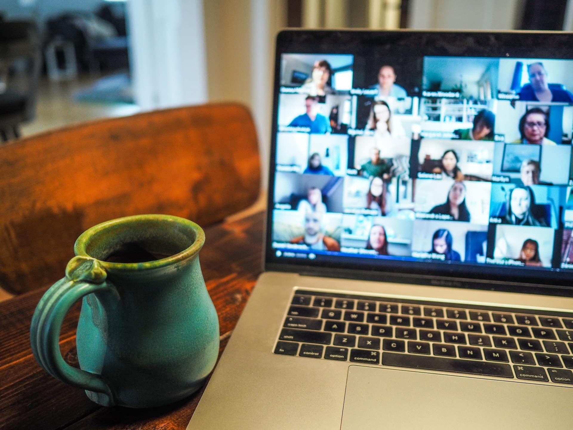 laptop on conference call with mug beside it